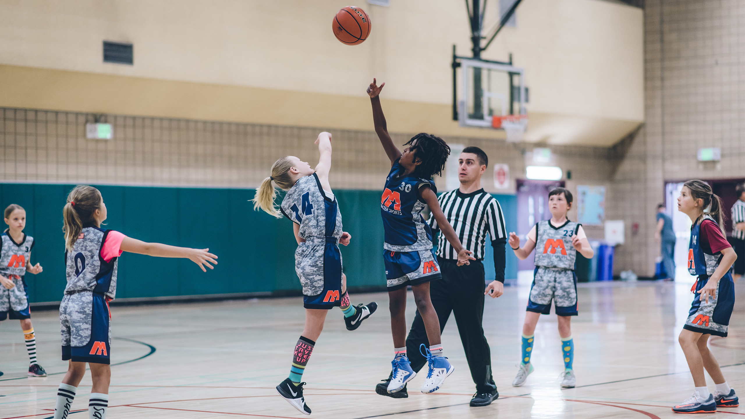 Jump ball at a Master Sports youth basketball game